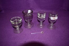 Four 19th century penny lick /deceptive glasses and one small spoon.