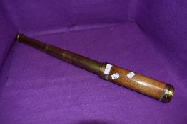 A brass and wood telescope.