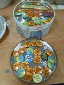 A tin of collectable/erotic retro pin badges.