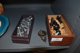 Four pivoting cannons, a box of chess pieces and a semi precious stone pendant.