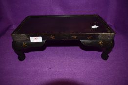 An early 20th century lacquered oriental stand.