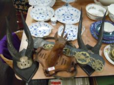 A pair of antique taxidermy Ibok or similar African animal horns and black forest style carved