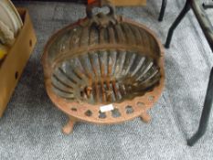 A vintage cast iron oyster design fire grate or grill insert for inglenook or similar