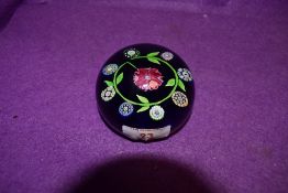 A vintage paperweight having flowers to centre, thought to be Perthshire underside number appears to