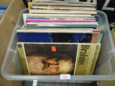 A selection of vinyl records and albums including pop and rock interest