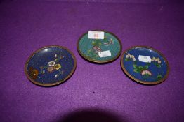 Three small cloisonné pin dishes having floral pattern on cobalt blue and teal green grounds.