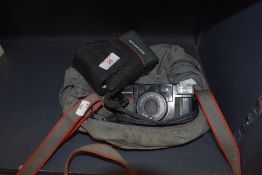 An olympus camera and case.