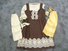 A vintage ladies dirndl dress and blouse and two similar styled aprons,around 1960s.