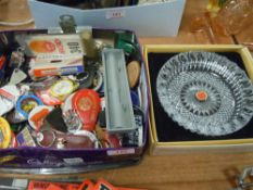 A biscuit tin containing collectable key rings,badges and more.