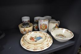An assortment of Royal Doulton Bunnykins plates and bowls,and various coronation mugs and similar.