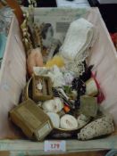 A vintage basket with lid containing an assortment of vintage and antique haberdashery including