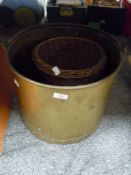 A large brass effect style coal bucket and similar wicker basket
