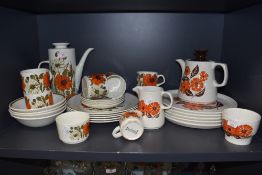 A selection of retro ceramics having vibrant orange floral patterns, one being Barker Bros Orange