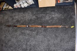 A tribal spear having leather and hide handle wrough iron head and tip possibly from the Maasai