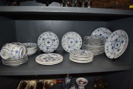 A large collection of Royal Copenhagen plates, cups and saucers,around thirty six items.