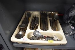 An assortment of vintage cutlery including cork crew , spoons and knives and forks.