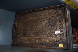 An early 20th century carved floral tray having dove tailed joints.