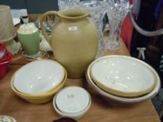 A selection of cream ware kitchen bowls and similar butter dishes also large Hillstonia jug