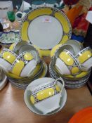 A part tea service in an art deco design black and yellow grounds by Victoria Bohemain styled