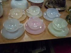 A set of Arcopal harlequin tea cups and saucers in fine condition