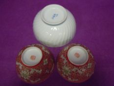 Three Chinese rice or noodle bowls two typical red glaze and larger white glaze footed ribbed and