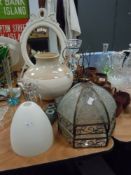 A selection of shabby chiq style decorations including glass shades, large glazed pot candle holders