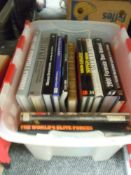 A box full of books of Ferrari and formula one interest.