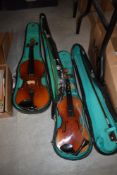 Two student violins and cases`