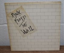 A copy of the Wall by Pink Floyd with inners and stickered sleeve