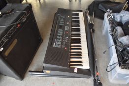 A Yamaha PDR 200 keyboard, stand and a microphone stand