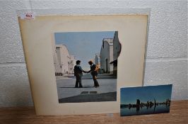 A copy of Wish you were Here by Pink Floyd with the postcard