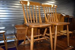 A pair of vintage solid seat kitchen chairs