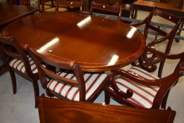 A reproduction Regency extending dining table and six (four plus two chairs)