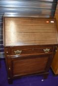 An early 20th Century mahogany and inlaid bureau, having cupboard base