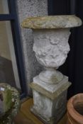 A large concrete garden urn on plinth, overall height approx. 100cm