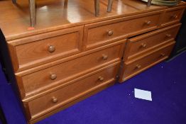 A vintage teak effect low chest of three over two over two drawers, dimensions approx. W150cm