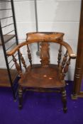 An early 20th Century stained frame elbow chair