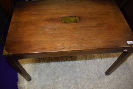 A modern mahogany campaign style coffee table