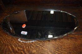 A vintage frameless wall mirror, width approx. 56cm