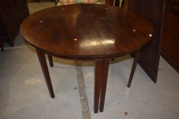 A Georgian mahogany 'D' end dining table having single centre leaf, on square tapered legs, diameter