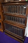 Am early 20th Century oak three tier stacking bookcase in the Globe Wernicke style having stepped