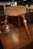 A 19th Century stained frame piano or similar stool on triple splay turned legs