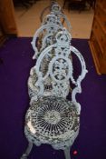 A set of four cast aluminium garden chairs
