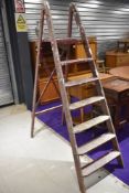 A set of vintage wooden decorators ladders