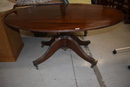 A late 19th century mahogany composite dining table having oval top on bulbous column and