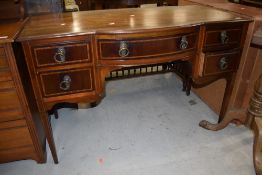 An early 20th Century mahogany and inlaid desk/dressing table , semi bow front , approx. width