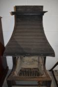 A vintage cast iron open fire place with integral hood