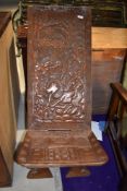A tribal art carved ethnic palaver chair, depicting hunting scene