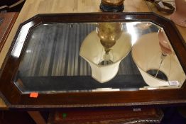 A stained frame canted wall mirror, width approx. 77cm