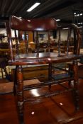 A traditional stained frame spindle back armchair having turned frame and studded leather seat